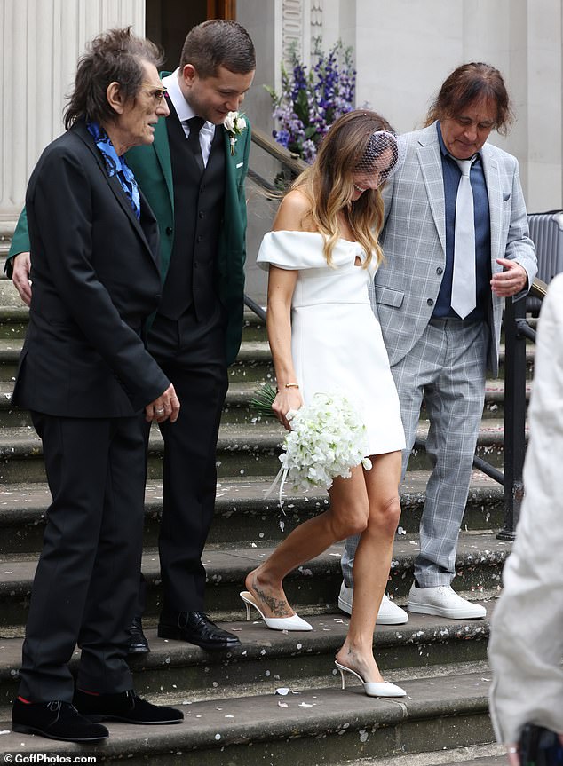 The bride slipped her feet into a pair of matching heels and completed the look with a netted veil and gorgeous bouquet