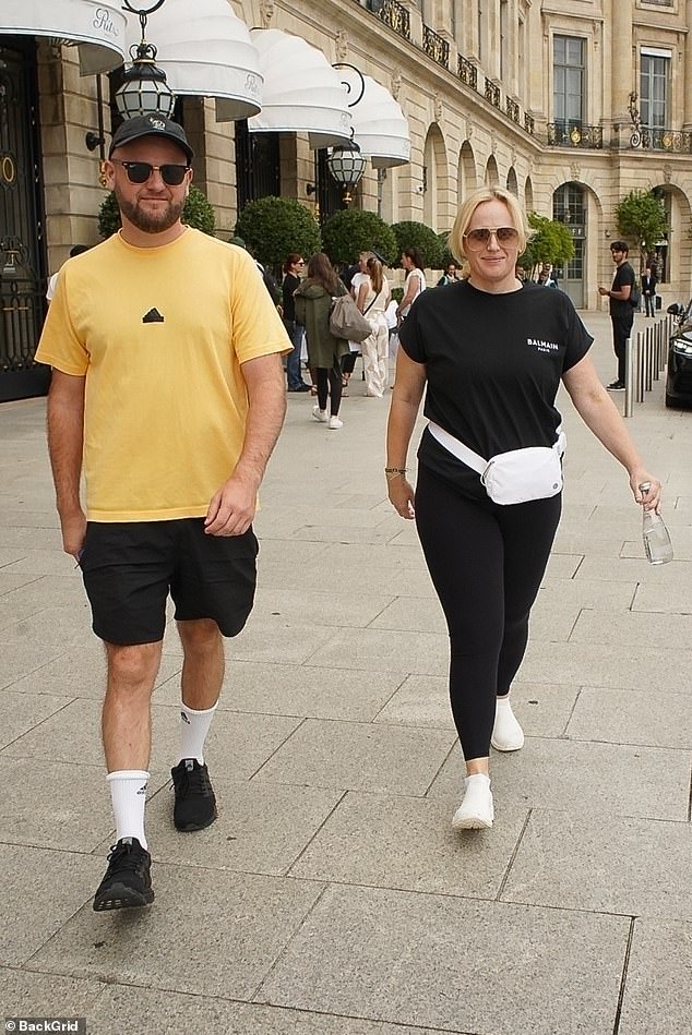 The Aussie star, 44, opted for cosy black leggings accessorising with a stylish white belt bag as she was seen alongside a male pal