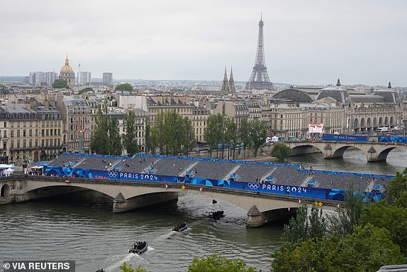 Paris 2024 Olympics - Paris, France - July 26, 2024. Police boats patrol the Seine river in Paris, France, ahead of the opening ceremony of the 2024 Summer Olympics, Friday, July 26, 2024. Ricardo Mazalan/Pool via REUTERS