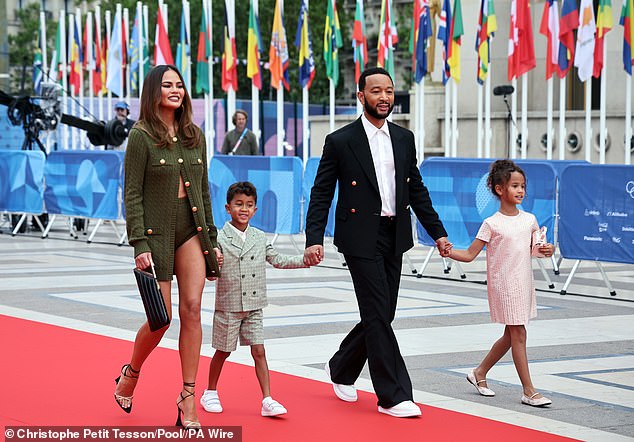 Chrissy Teigen put on a leggy display as she joined husband John Legend and children Luna, 8, and Miles, 6, at the Olympics Opening Ceremony