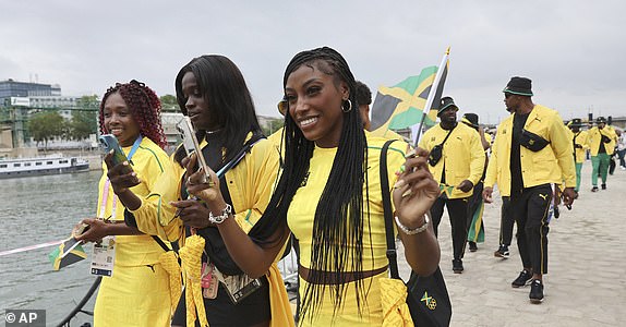 Athletes of Jamaica arrive to board their boat on the Seine River in Paris, France, before the opening ceremony for the 2024 Summer Olympics, Friday, July 26, 2024. (Nir Elias/Pool Photo via AP)