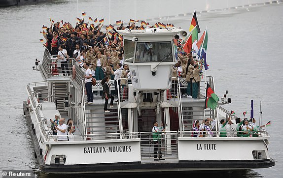 Paris 2024 Olympics - Opening Ceremony - Paris, France - July 26, 2024. Athletes of Germany aboard a boat in the floating parade on the river Seine during the opening ceremony. REUTERS/Albert Gea