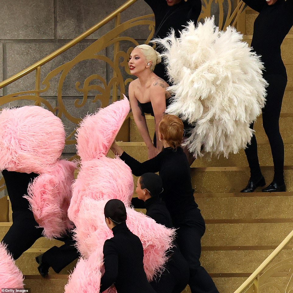 She sported glamorous stage make-up with her blonde locks slicked back into a chic chignon, and later donned a pair of stylish black opera gloves