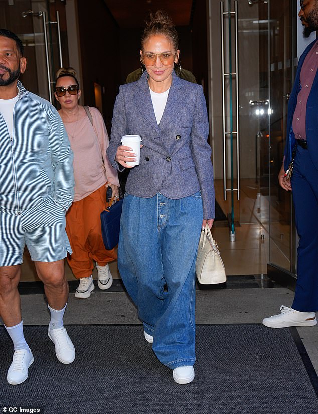 The Atlas star ¿ who turned 55 on Wednesday ¿ wore a blue-grey blazer that accentuated her trim waist with a white t-shirt underneath. With the star was her manager Benny Medina and her photographer Ana Carballosa