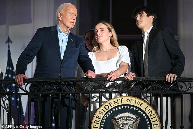 Biden (L) and grandchildren Finnegan Biden and Robert Hunter Biden II (R) watch the Independence Day fireworks display