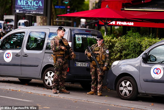 Armed guards near the Plaza de la Bastilla, Paris. The Opening Ceremony of the Paris 2024 Olympic Games takes place on Friday July 26, along the River Seine