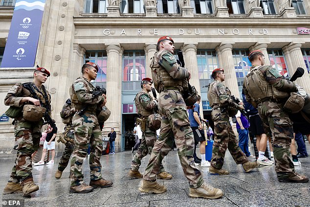 French military personnel patrol outside Gare du Nord station in Paris after a 'coordinated' attack on rail infrastructure