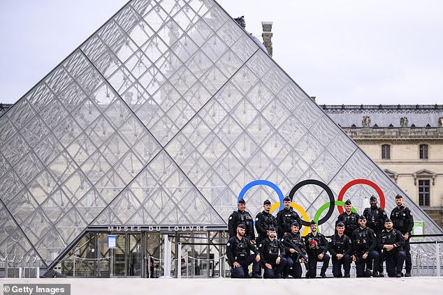 Police patrols outside at the Louvre ahead of the Opening Ceremony of the Olympic Games