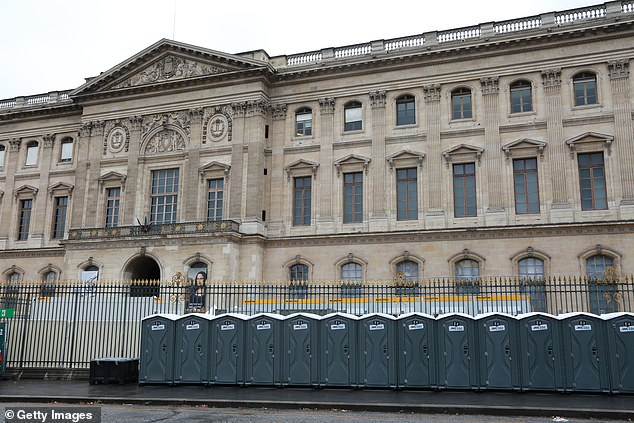 A long line of public toilets booths have been installed near the Seine River, next to the Louvre Museum