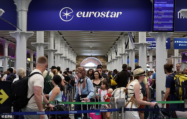 Rail passengers queue up at Eurostar rail terminal at St. Pancras International station in London, Britain, 26 July 2024