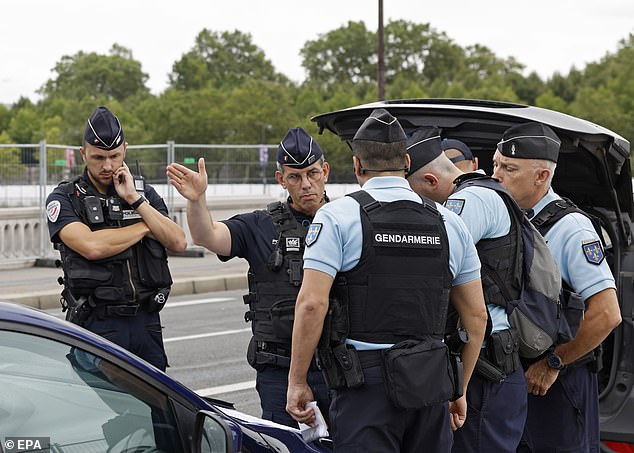 French police officers discuss security checks ahead of the Opening Ceremony of the Paris 2024 Olympic Games, in Paris, France, 26 July 2024