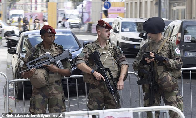 Armed guards in Paris head of the start of the Paris 2024 Olympic Games