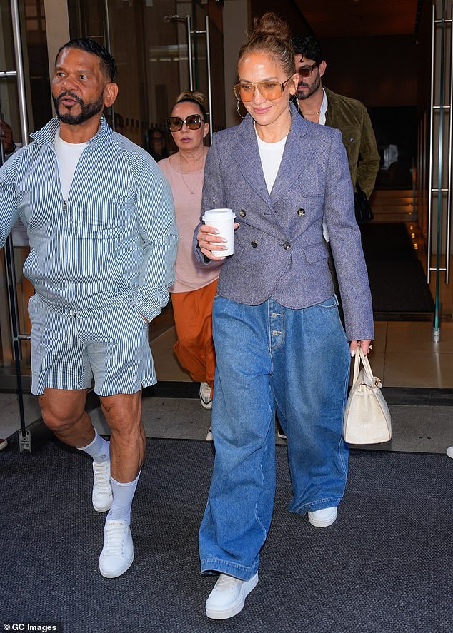 She paired the preppy look with wide-legged, button-fly jeans and white sneakers