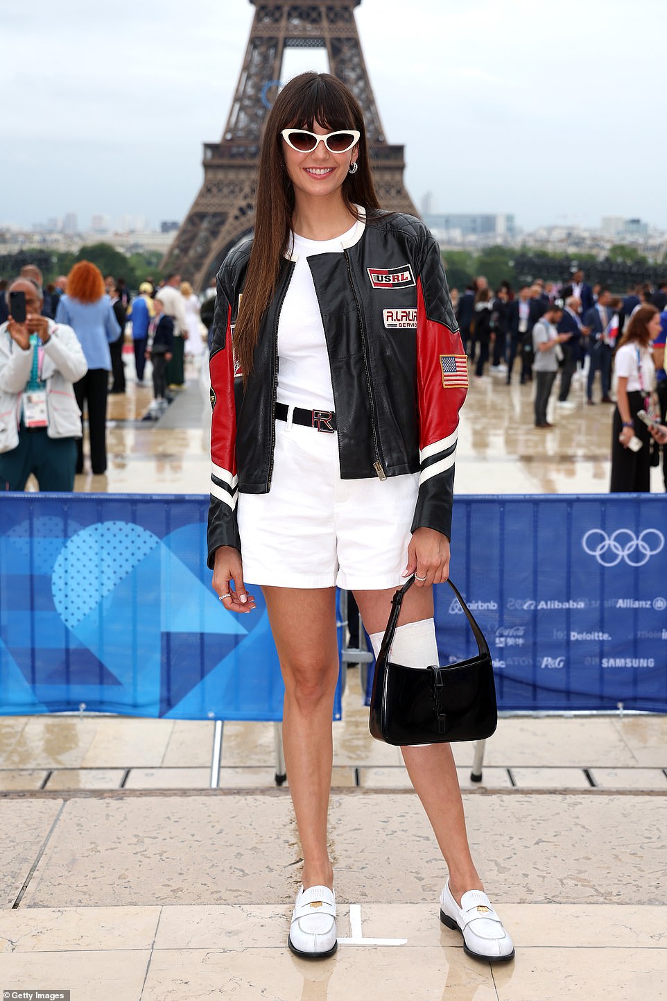 Former Vampire Diaries star Nina Dobrev, 35, gave a wide smile as she posed in a cool ensemble made up of short white outfit, matching shoes, leather jacket and small black handbag