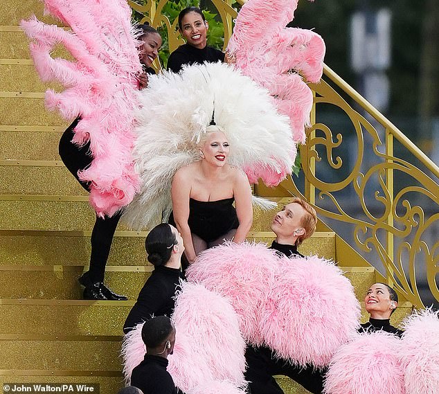 The Bad Romance star, 38, stunned in black leotard and white feathers as she graced the international stage with her rendition of Mon Truc en Plumes