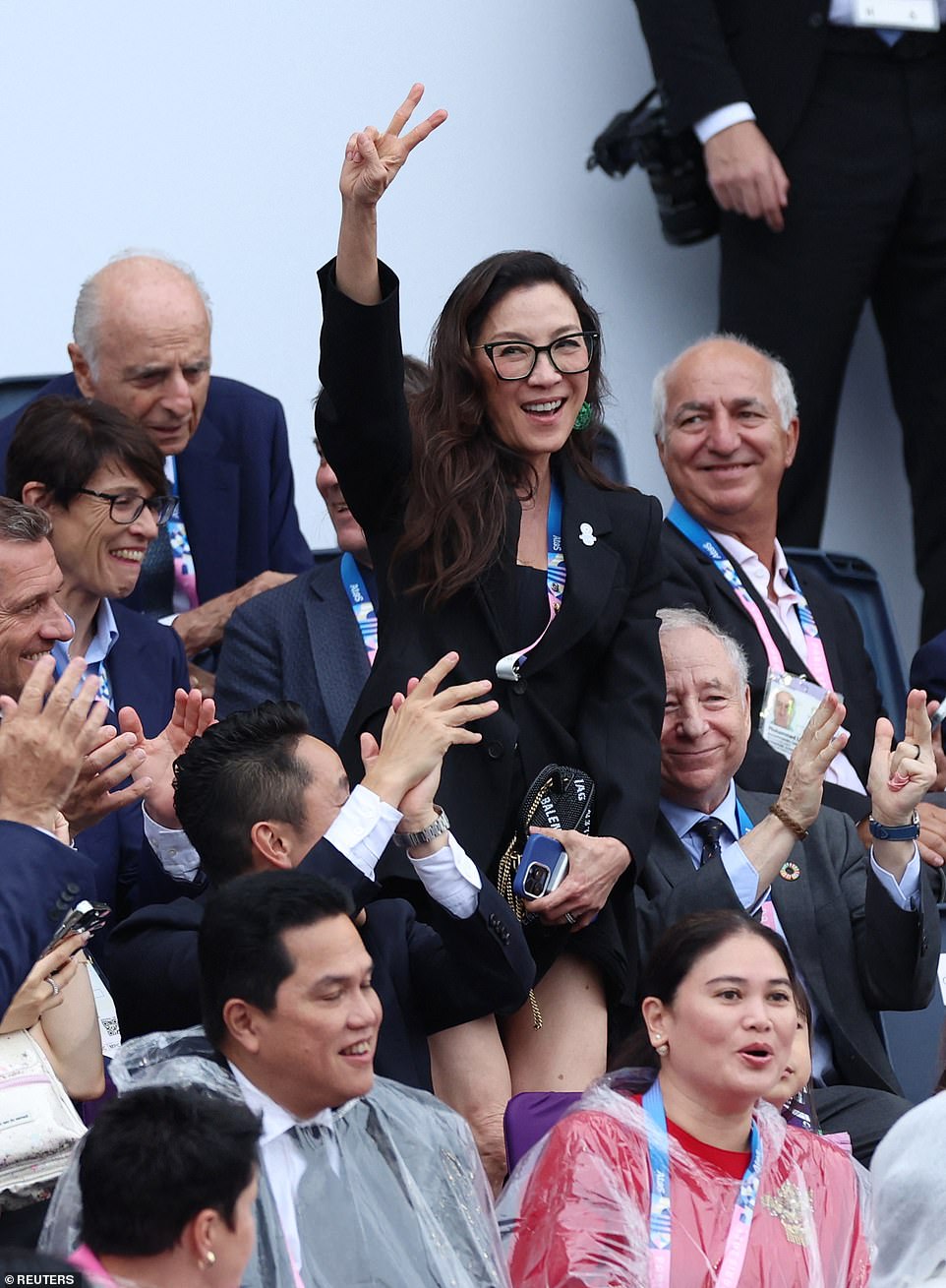 Ariana's other Wicked co-star Michelle Yeoh - who will play Madame Morrible in the upcoming musical - threw a peace sign as she was spotted in the crowds