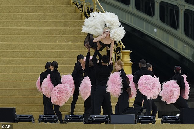 The star channeled old Hollywood glam as she was lifted into the air as she blew a kiss to the cameras