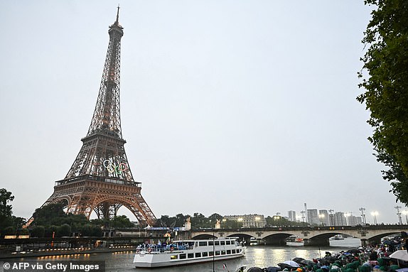 The delegations from Ethiopia, Fiji and Finland sail in a boat along the river Seine during the opening ceremony of the Paris 2024 Olympic Games in Paris on July 26, 2024, as the Eiffel Tower is seen in the background. (Photo by Paul ELLIS / AFP) (Photo by PAUL ELLIS/AFP via Getty Images)