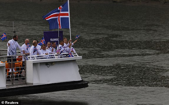 Paris 2024 Olympics - Opening Ceremony - Paris, France - July 26, 2024. Athletes of Iceland are seen aboard a boat in the floating parade on the river Seine during the opening ceremony. REUTERS/Evgenia Novozhenina