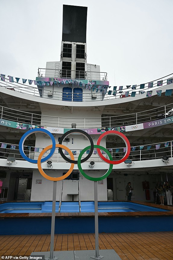 This photograph taken during a press visit shows the deck of the Aranui 5 cruise ship hosting surf athletes for the Olympic Games bearing the Olympics rings, moored in Vairao Bay, near the Teahupoo surf spot, ahead of the opening ceremony of the Paris 2024 Olympic and Paralympic Games, on July 19, 2024. (Photo by Jerome BROUILLET / AFP) (Photo by JEROME BROUILLET/AFP via Getty Images)