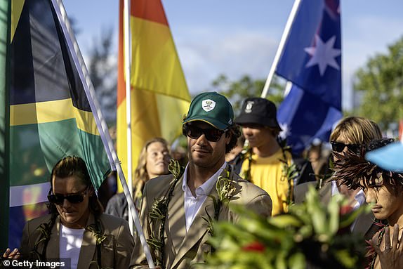 TEAHUPO'O, FRENCH POLYNESIA - JULY 26: Jordy Smith of Team South Africa walks with the South African flag during the opening ceremony of the Olympic Games Paris 2024 on July 26, 2024 in Teahupo'o, French Polynesia. (Photo by Ed Sloane/Getty Images)