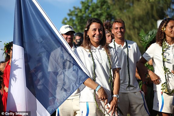 TEAHUPO'O, FRENCH POLYNESIA - JULY 26: Johanne Defay of Team France walks with the French flag during the opening ceremony of the Olympic Games Paris 2024 on July 26, 2024 in Teahupo'o, French Polynesia. (Photo by Sean M. Haffey/Getty Images)