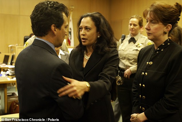 Kamala Harris, then San Francisco district attorney, speaks to a relative of a slain cop