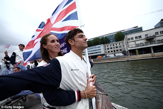 Team GB diver Tom Daley and rower Helen Glover reenact the Titanic as they travel down the River Seine