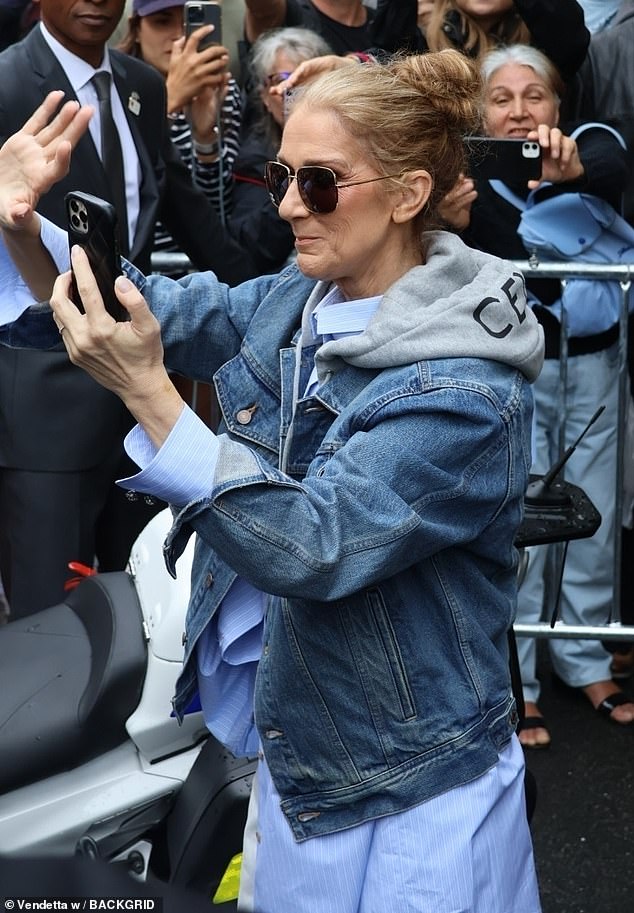 Leaving her hotel, Celine was seen with her phone clutched to hand taking pictures and videos of her fans as she is reportedly getting ready to make a come back during tonight's Olympic events