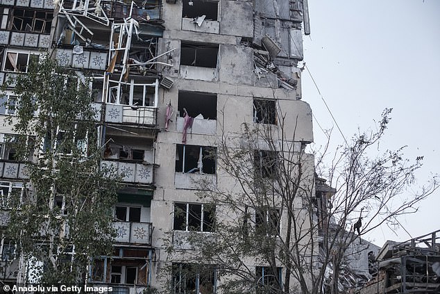 A severely damaged building with smashed windows and crushed balconies in New York, Donetsk Oblast