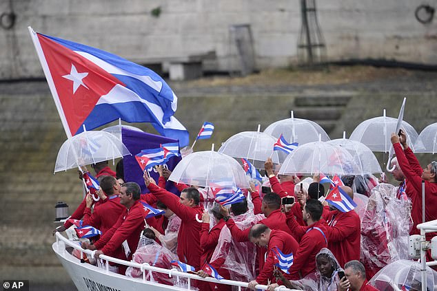 The boat carrying team Cuba makes its way down the Seine