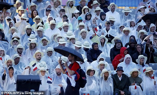 A sea of ponchos on the banks of the River Seine tonight as they watch the Opening Ceremony