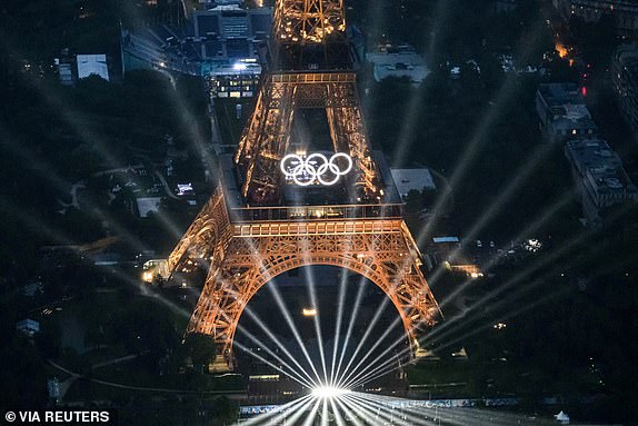 Paris 2024 Olympics - Opening Ceremony - Paris, France - July 26, 2024. - An aerial view of the Eiffel Tower and the Olympics Rings lightened up during the opening ceremony of the Paris 2024 Olympic Games. LIONEL BONAVENTURE/Pool via REUTERS