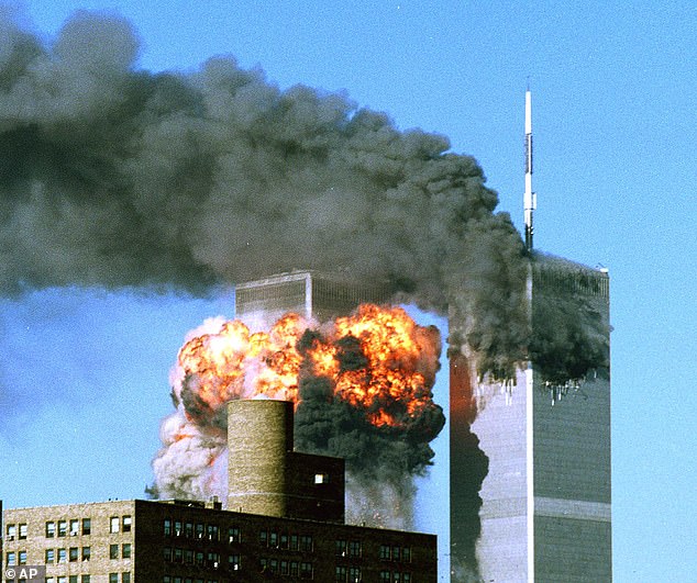 Smoke billows from the top of One World Trade Center and flames and debris explode from Two World Trade Center, Tuesday, Sept. 11, 2001