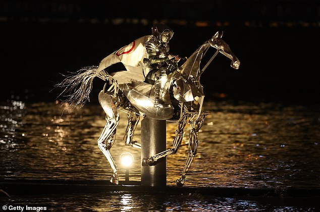 A horsewoman carrying the Olympic Flag down the River Seine