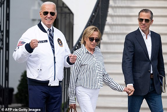 US President Joe Biden, wearing a Team USA Olympics jacket, walks alongside his sister Valerie Biden Owens (C) and son Hunter Biden (R) to Marine One prior to departing from the South Lawn of the White House in Washington, DC, July 26, 2024 as he travels to Camp David for the weekend. Biden is travelling to Camp David for the weekend. (Photo by SAUL LOEB / AFP) (Photo by SAUL LOEB/AFP via Getty Images)