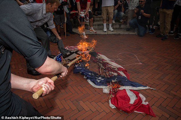 Protestors ignite an American flag at Union Station