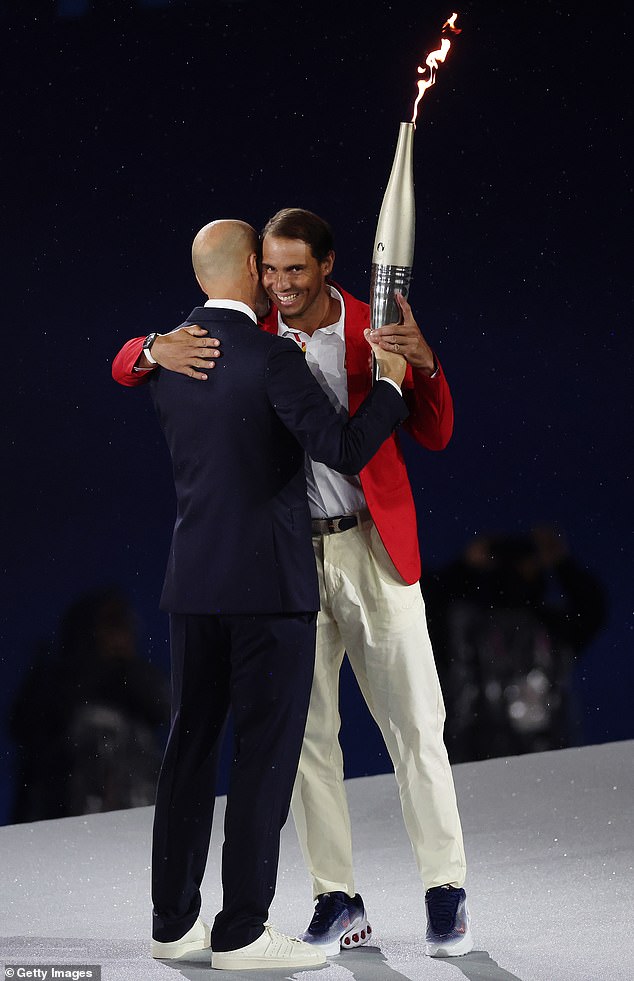 Zidane and Nadal hug as the Olympic torch is handed over