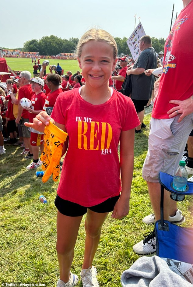 The young girl wore a Taylor Swift t-shirt and looked delighted to have caught Kelce's gloves