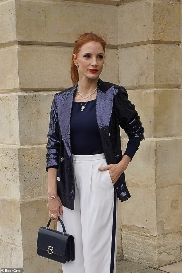 Jessica posed in front of an ornate gate and the marble facade of a building as the 2024 Summer Olympic Games in Paris began