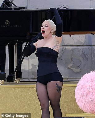 Lady Gaga, 38, was also seen in a a small black bodysuit complete with white feathers as seen belting out her rendition of Mon Truc en Plumes in French during her performance at the opening ceremony, with all celebs braving the heavy rain