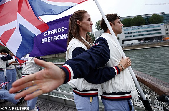 Paris 2024 Olympics - Opening Ceremony - Paris, France - July 26, 2024. Tom Daley and Helen Glover, Flagbearers of Britain pose during the opening ceremony of the Olympic Games Paris 2024. Naomi Baker/Pool via REUTERS