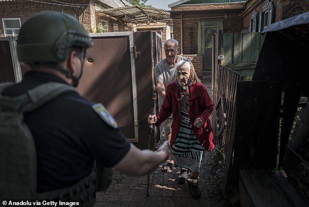 An elderly civilian being rescued in the town of New York, Donetsk Oblast, Ukraine