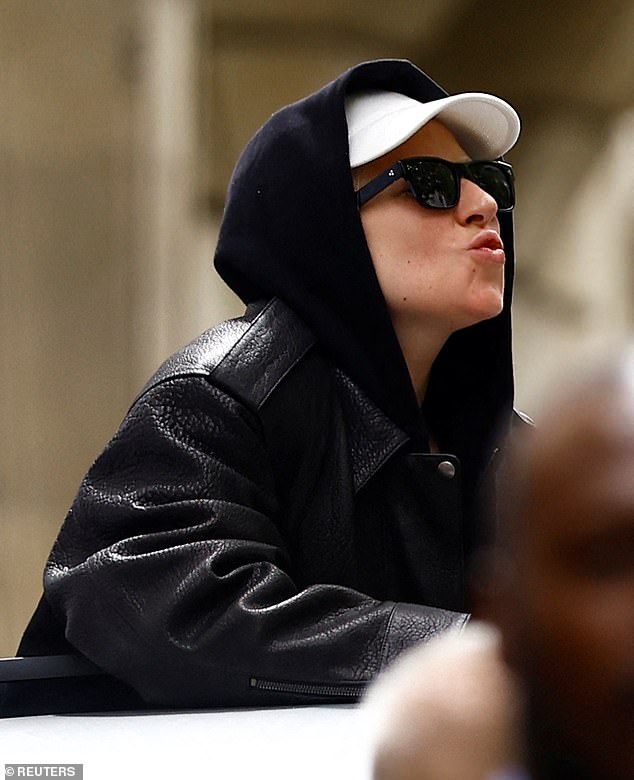 Lady Gaga, 38, blew kisses to fans as she stood through her sunroof of her car in Paris ahead of the 2024 Olympics on Friday