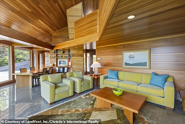 The 4,963 square-foot home is situated on Buckmaster Neck in Stonington, and was designed by local architect James W. Schildroth (pictured: The living and dining room area)