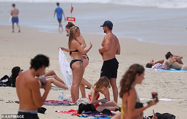 The northern part of Australia will be relentlessly warm and Brisbane is tipped to experience its hottest August day later this week - 34C (pictured stock photo of people at a Queensland beach)