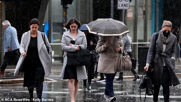 Different parts of the southern states are expecting a week of cold snaps, damaging gusts, showers, storms, snow and hail (pictured pedestrians in the rain)