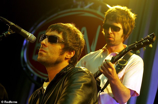 Liam Gallagher and Noel Gallagher are pictured performing live onstage in 2001