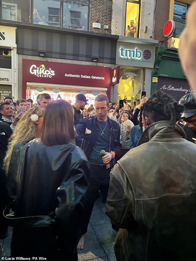 Lead singer Chris Martin , accompanied by rapper Burna Boy, walked into Grafton Street shortly after 8pm amid heightened security and an increased presence of the Irish police