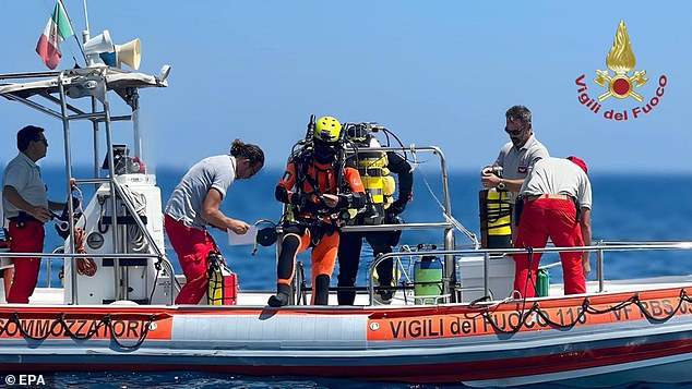 A handout video grab made available by Vigili del Fuoco (VVF), the Italian National Fire Brigade, shows rescue personnel of the special unit of divers of the National Fire Brigade and divers of the Italian fire brigade preparing to resume inspections of the Bayesian yacht's wreck